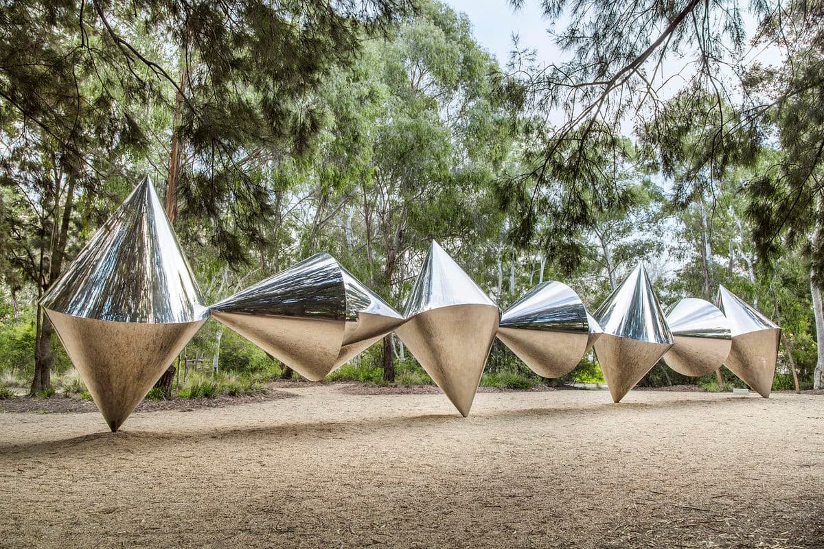 A photograph of seven alternating silver chrome cones