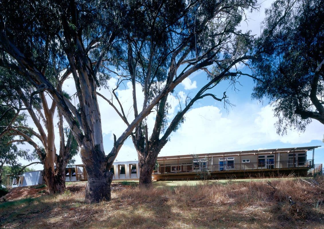 Photograph of trees and building in bush landscape