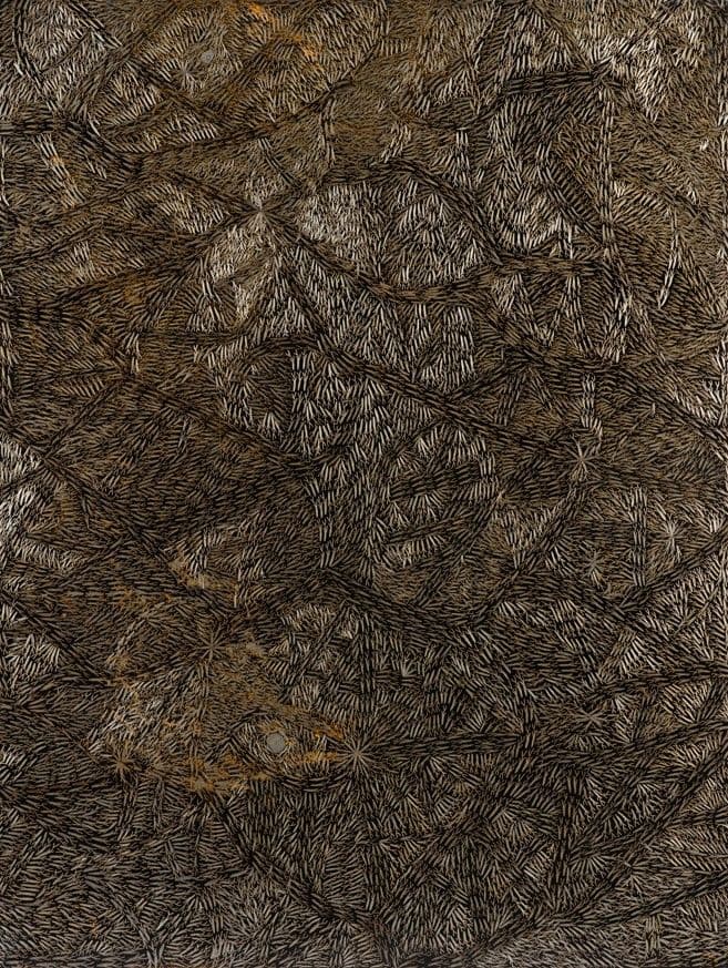 An image of an artwork that appears to be gold scratches over black metal