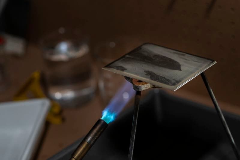 Detail of the blue flame of a blow torch heating the daguerreotype