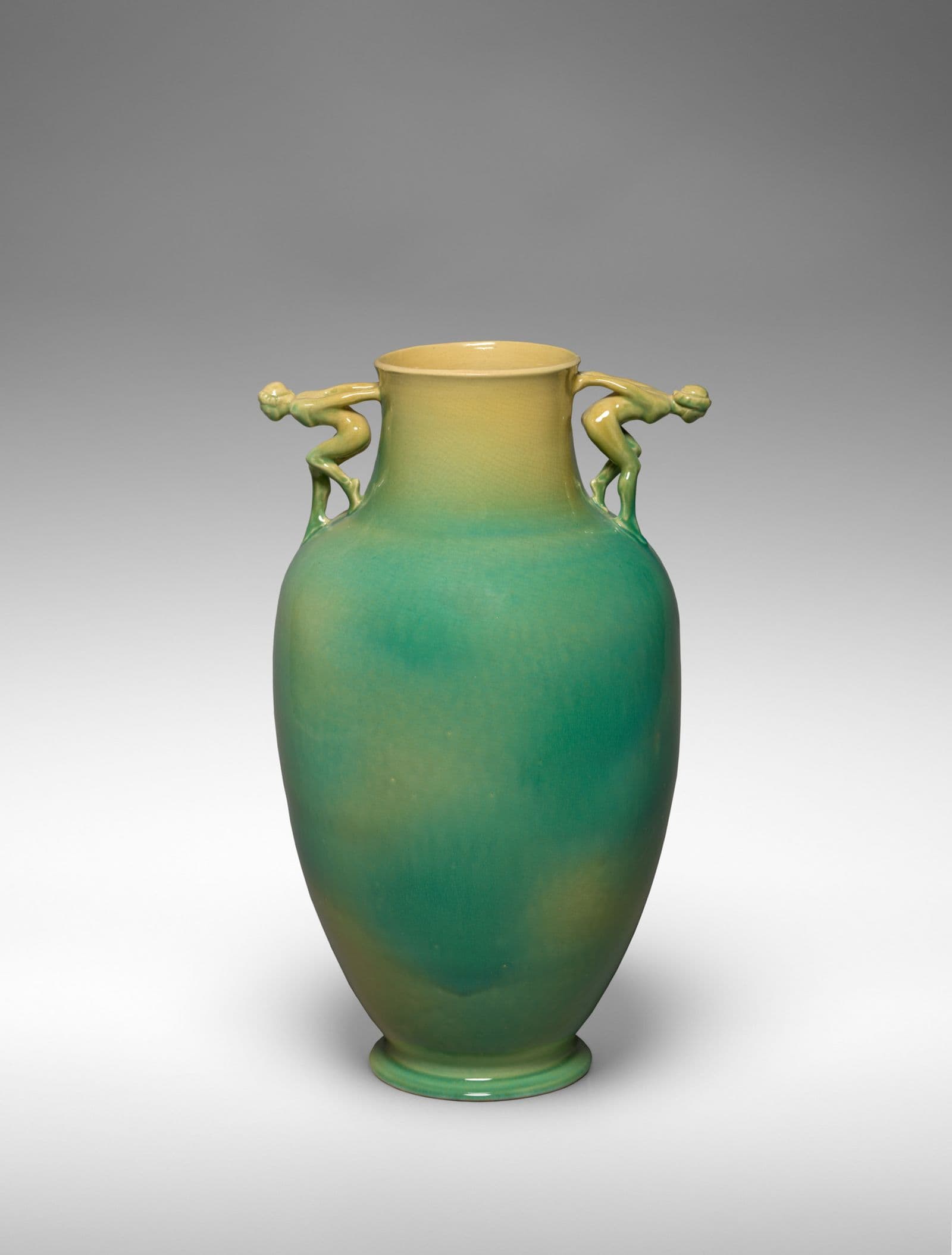 Green vase with human figures as handles