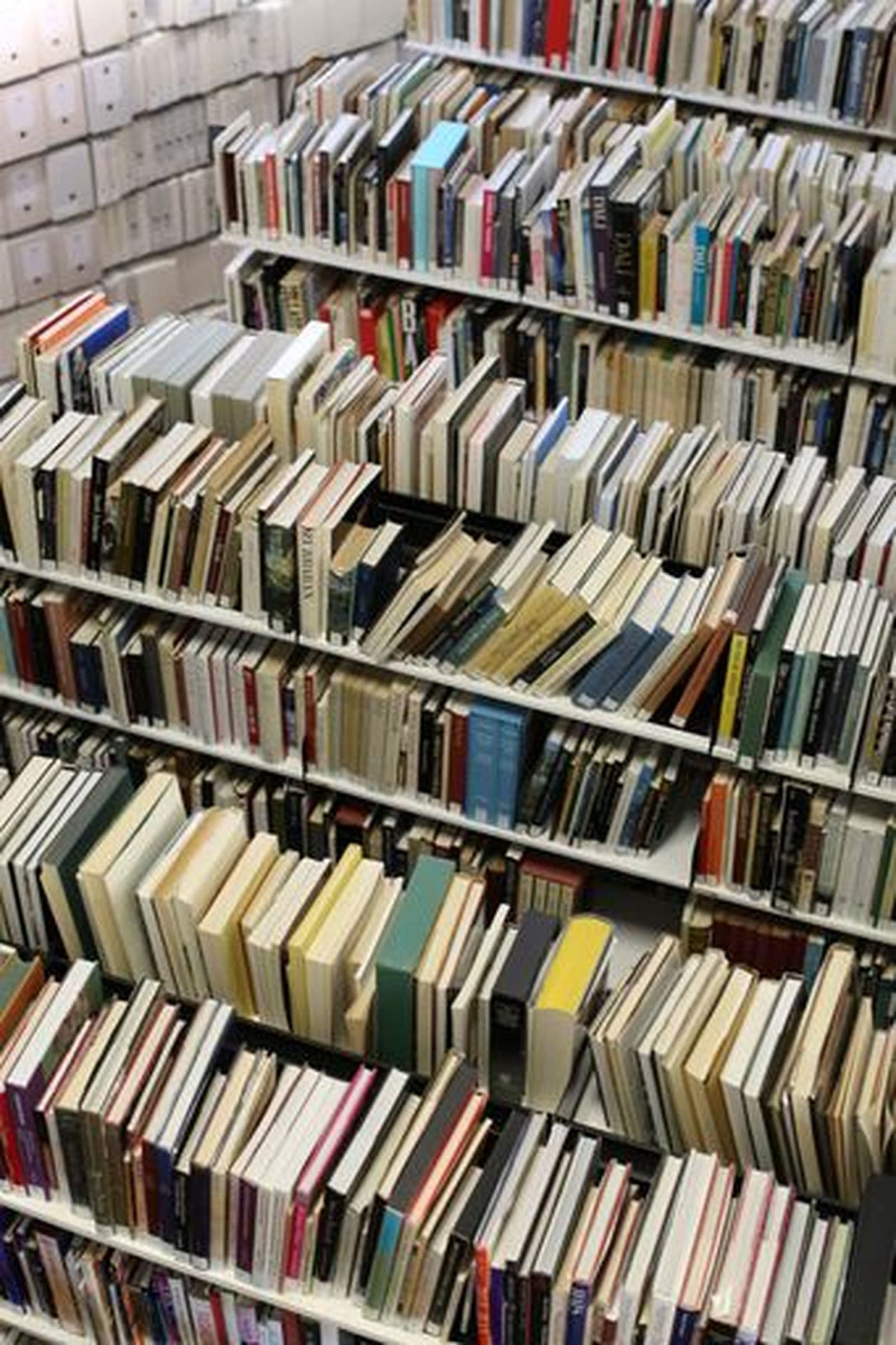 Photograph of library books on stacks overhead