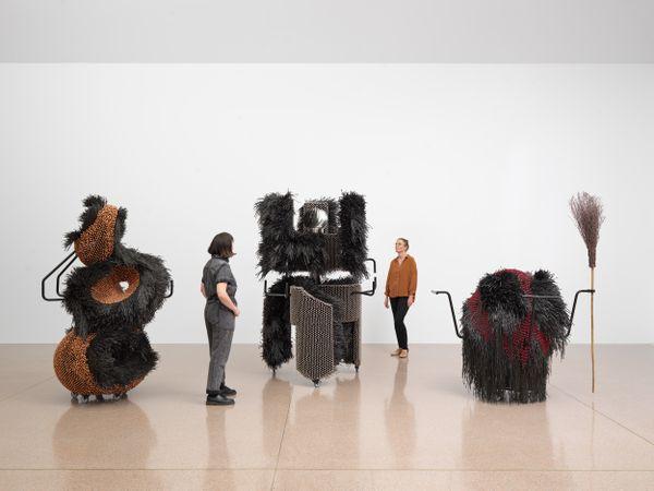 The artist's work pictured stationary in an empty room with two models.