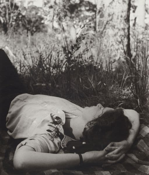 Black and white photograph of a sleeping woman's torso
