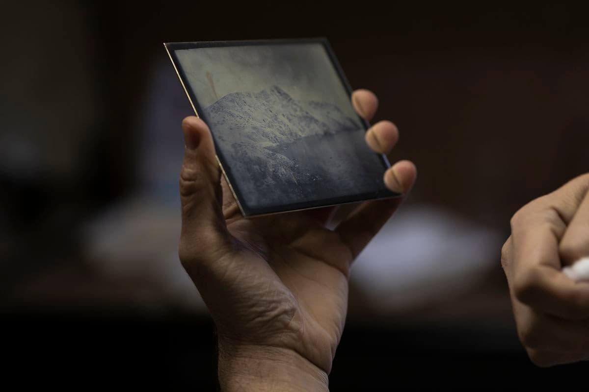 Detail of James Tylor's hand holding a finished daguerreotype photographic plate