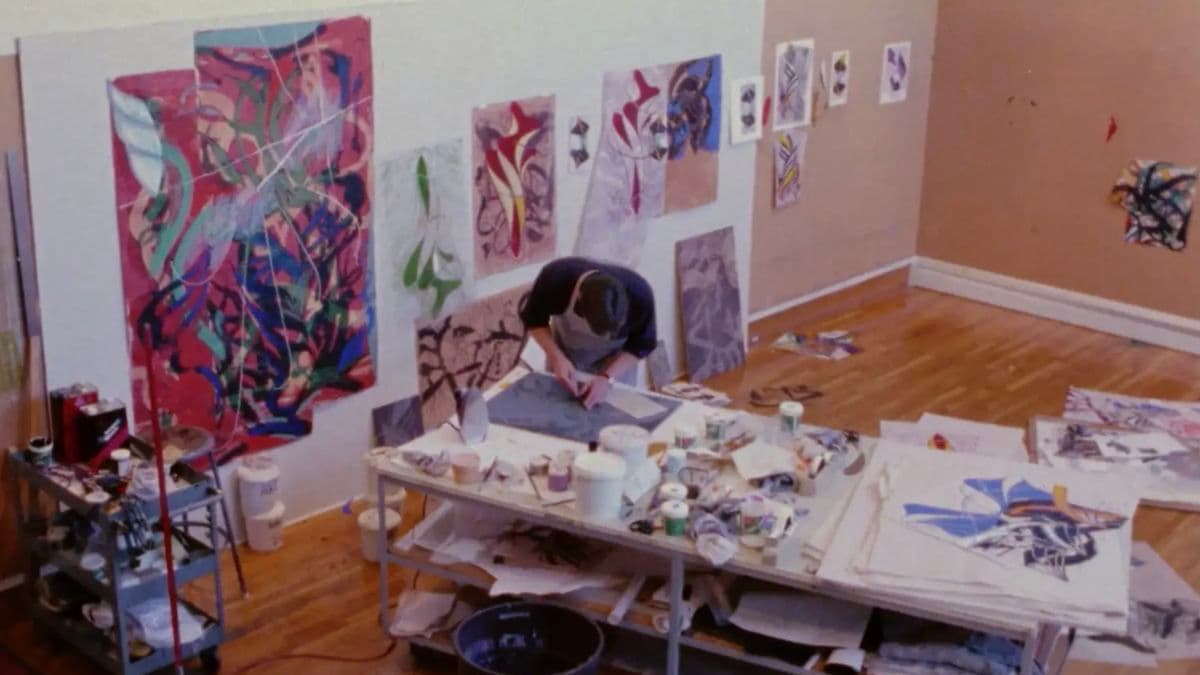 Video still of artist working in studio