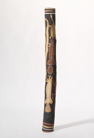 Traditional First Nations burial pole with red and yellow ochre snake, barramundi and tortoise imagery