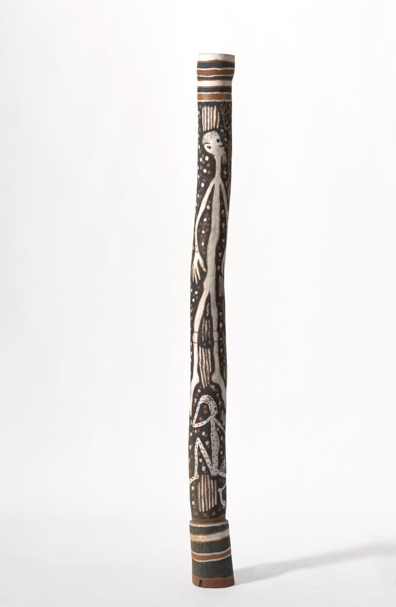 Tall black pole with white and red ochre human and spirit figures