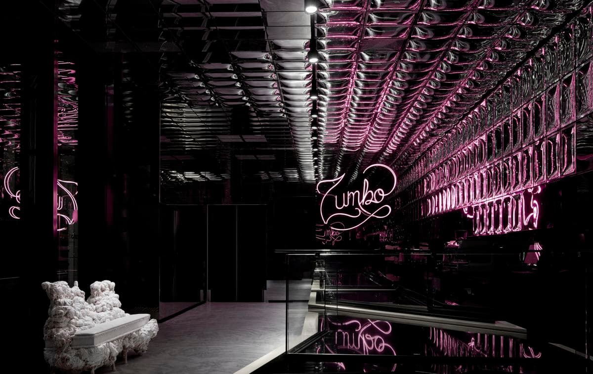 Photograph of interior room with chairs and neon