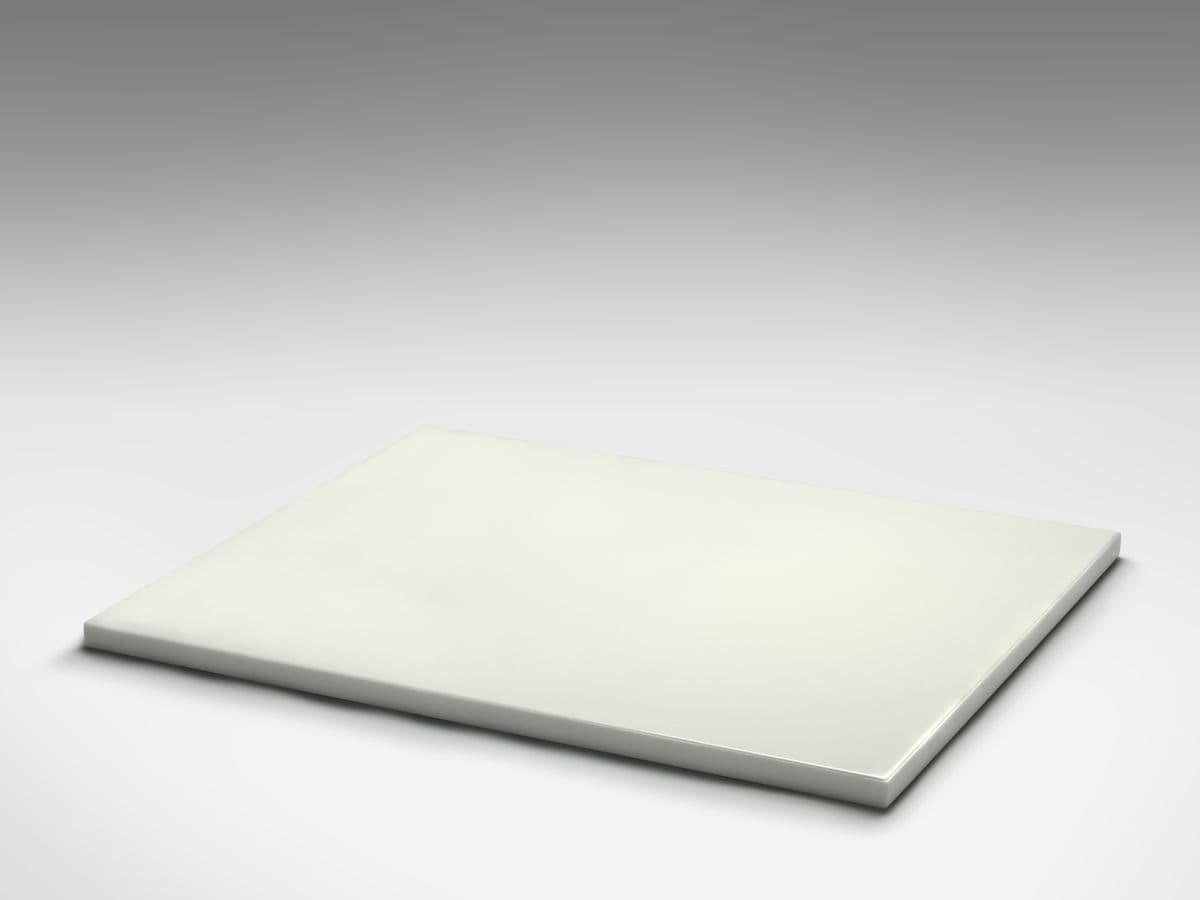 A large white stone with a thin layer of milk on it's surface.