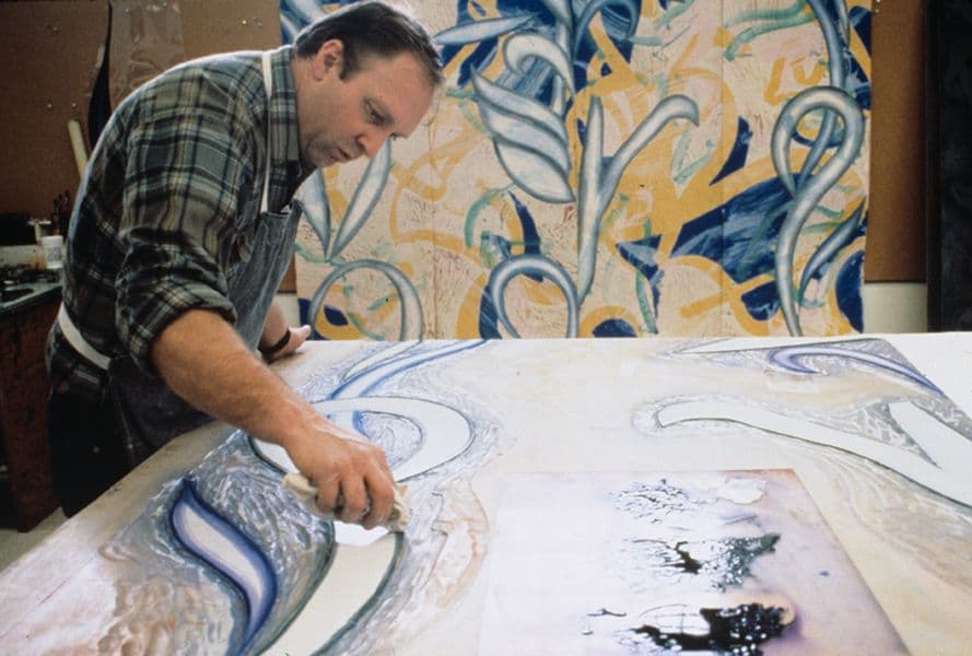 Colour photo of John Hutcheson inking woodblock for Steven Sorman’s ‘From away’