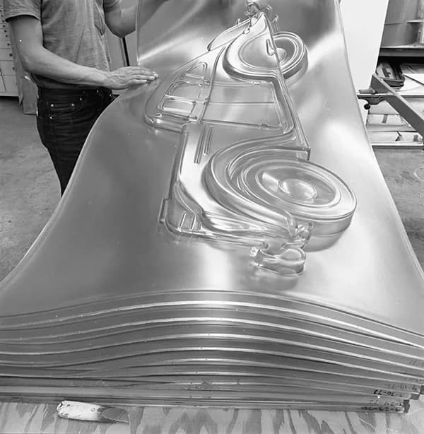 Black and white image of a Gemini employee inspects the newly re-cast Profile Airflow.