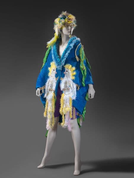 A mannequin with a fluffy jumper on it and hat made form feathers.