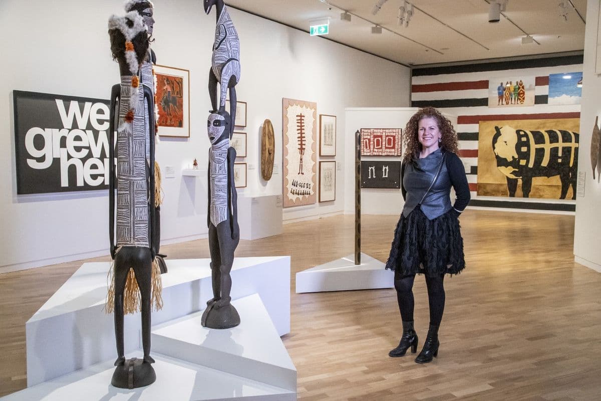 Kelli Cole stands in an art gallery