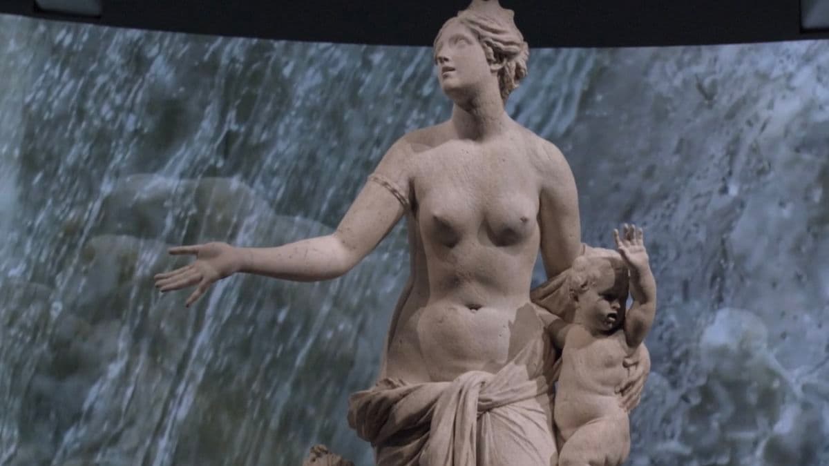 Video still of statue in exhibition