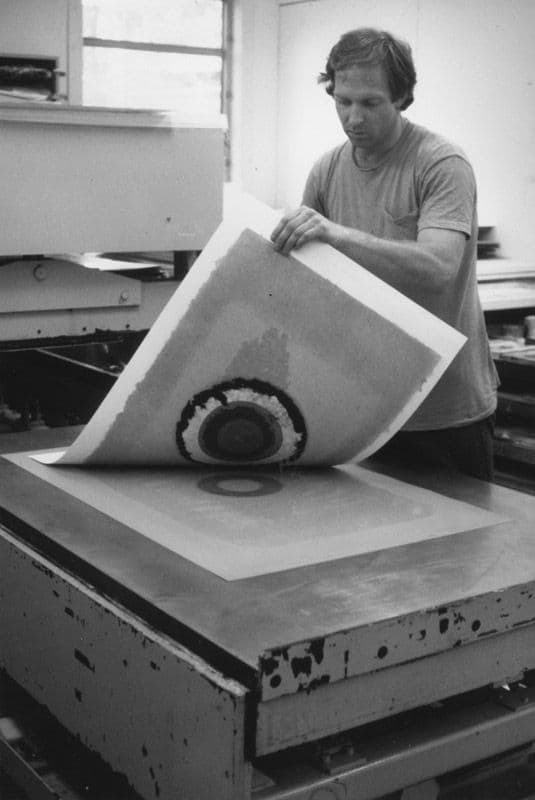 Black and white photograph of John Hutcheson pulling monotype print from Kenneth Noland's 'Circle II Series'