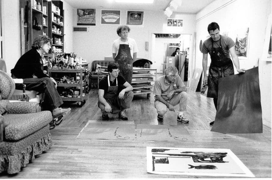 Black and white photograph of Helen Frankenthaler, Roger Campbell, Kenneth Tyler and Rodney Konopaki discussing 'Blue current' proof