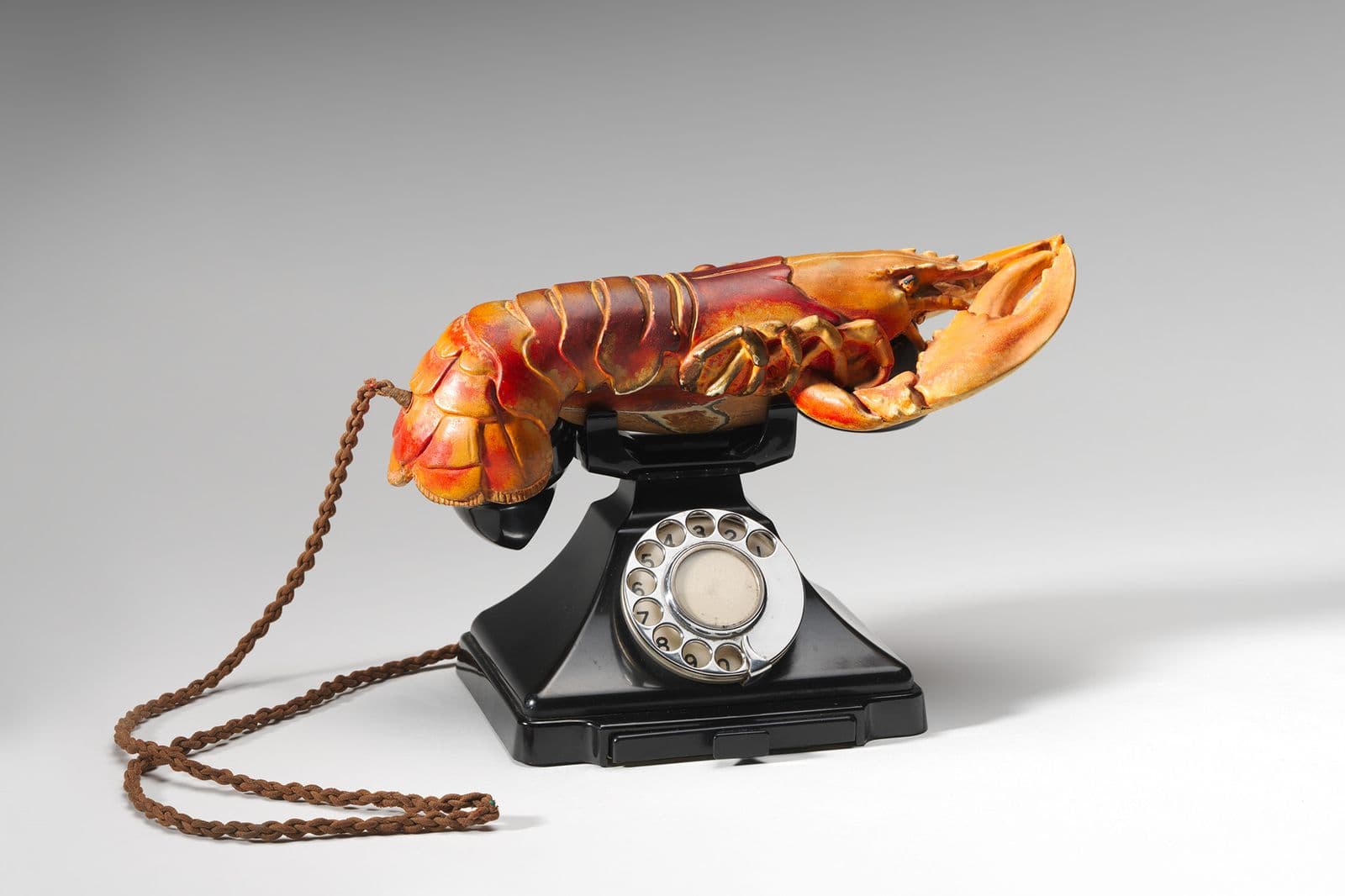Black rotary telephone with circular wheel finger dial with lobster claw as a the handset