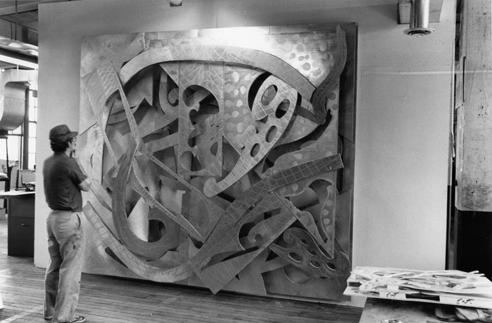 Frank Stella views ‘Mosport’ from his ‘Circuits’ series of relief paintings (in progress) on the wall of his studio