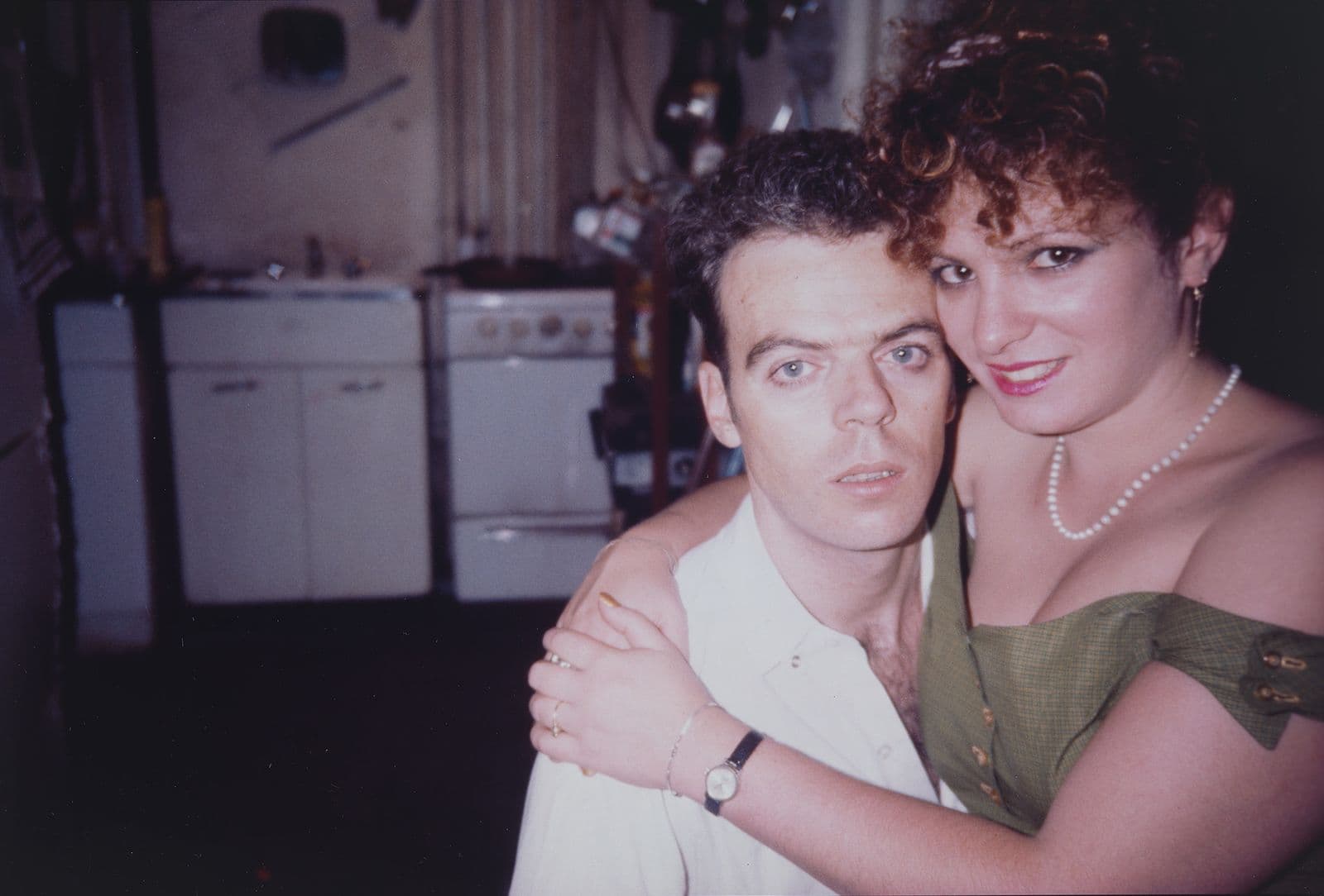 Colour Cibachrome photograph of a man and a woman, with the woman's arms around his neck smiling.