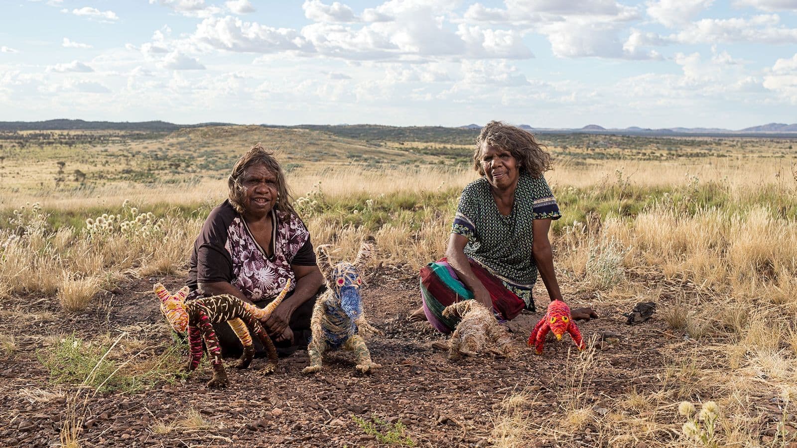 Photo of Roma Butler and Yangi Yangi Fox sitting side by side outside