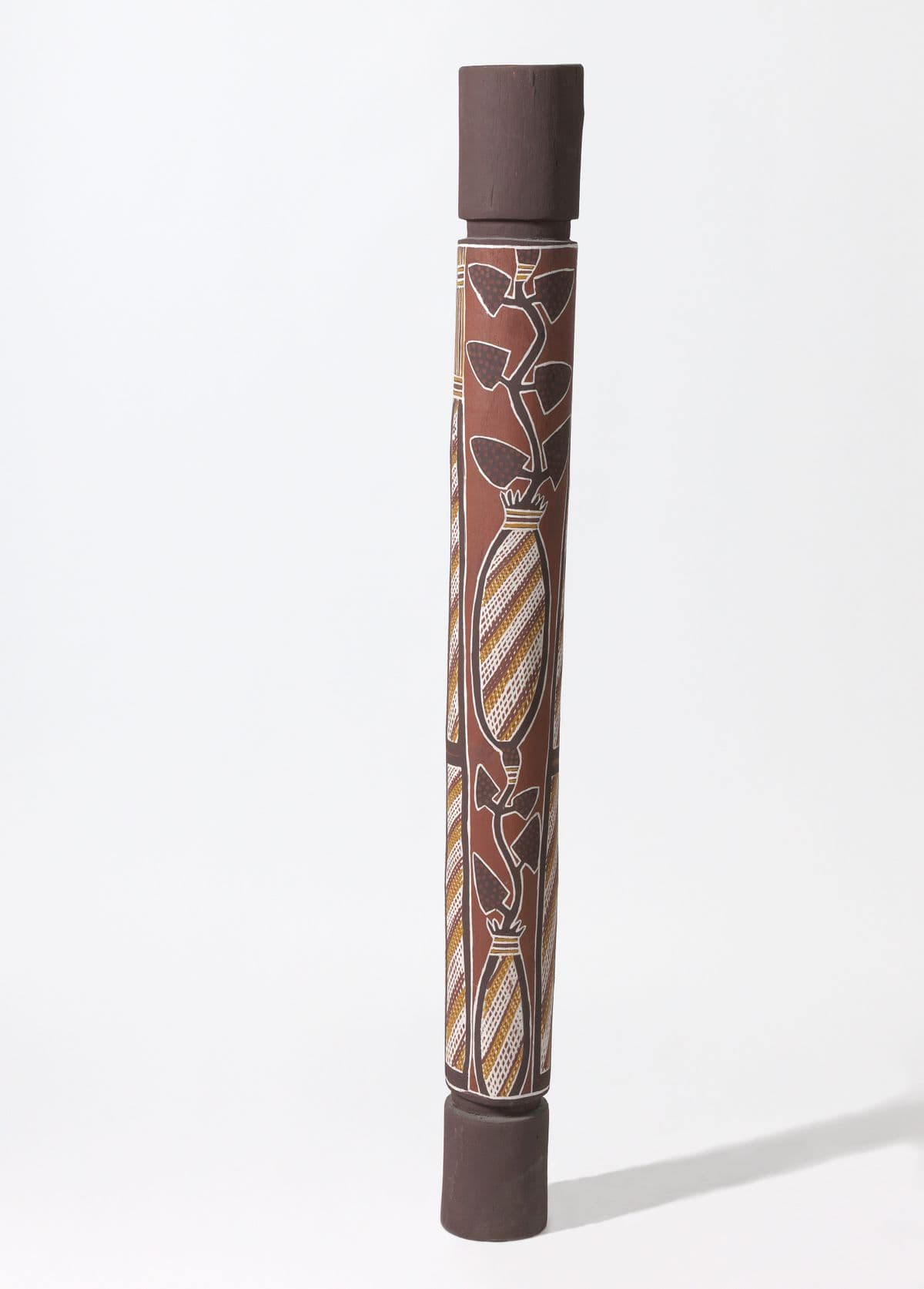 Dark brown pole with ochre, white and yellow figurative paintings of interconnected yams