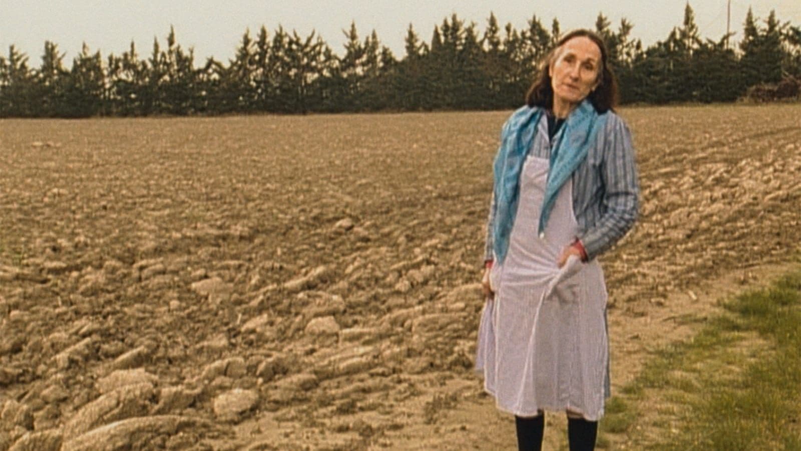 Film still of a woman in a field