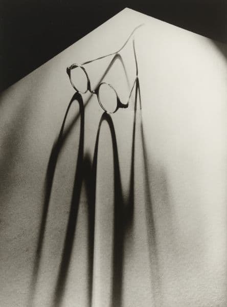 Photo of round-lens glasses drawing a long shadow