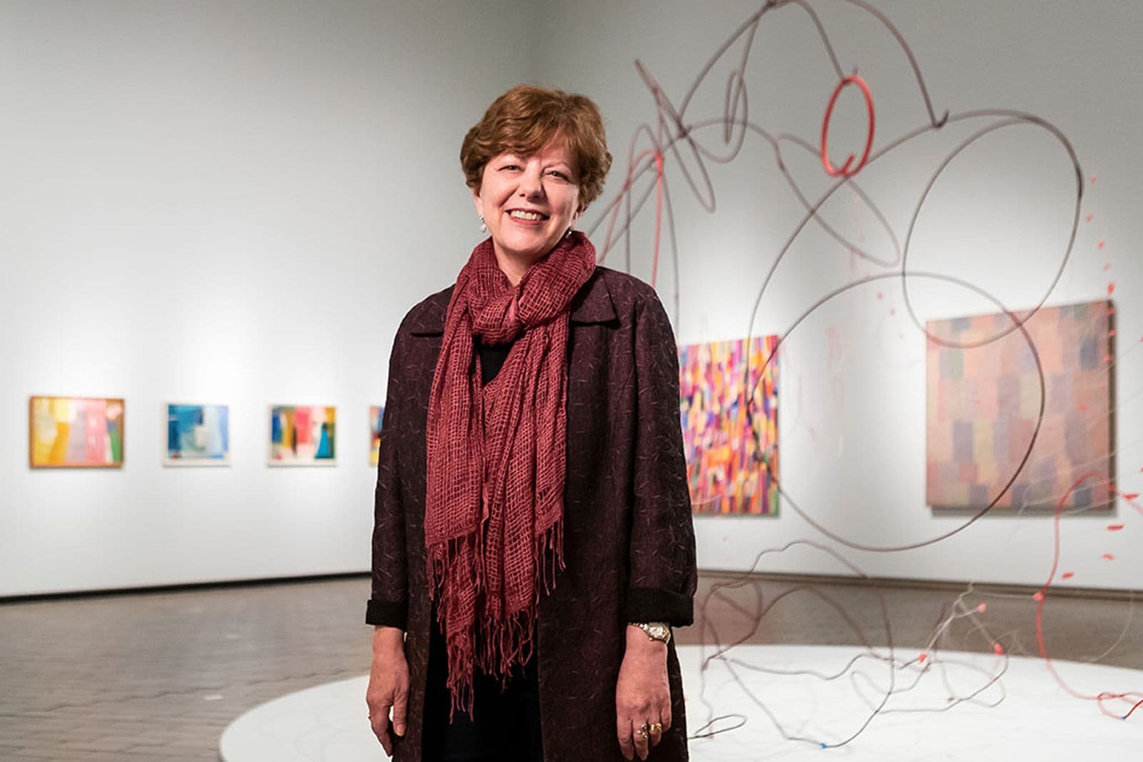 Deborah Hart stands inside the gallery