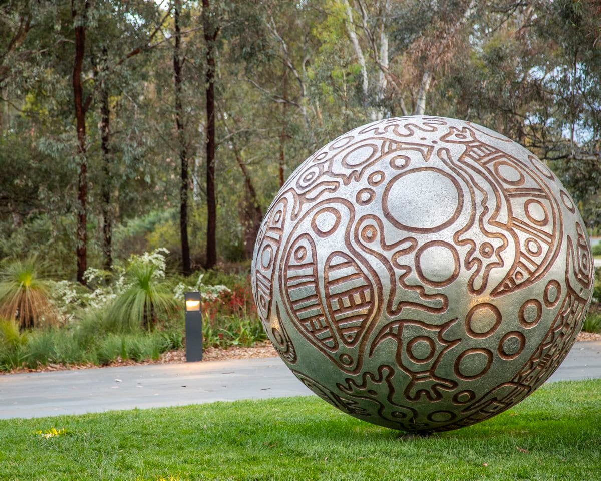A silver sphere with brown patterning on the outside