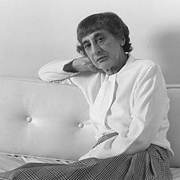 Photograph of older woman sitting on a couch