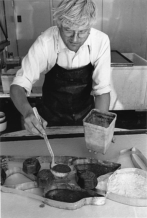 Black and White image of David Hockney working in his studio