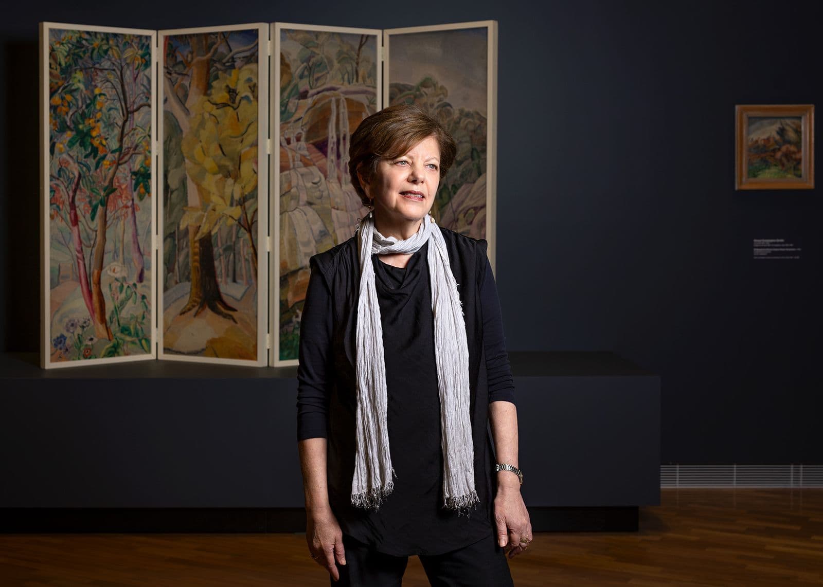 Installation view of Deborah Hart in Know My Name: Making it Modern, National Gallery of Australia surrounded by the paintings of Grace Cossington Smith