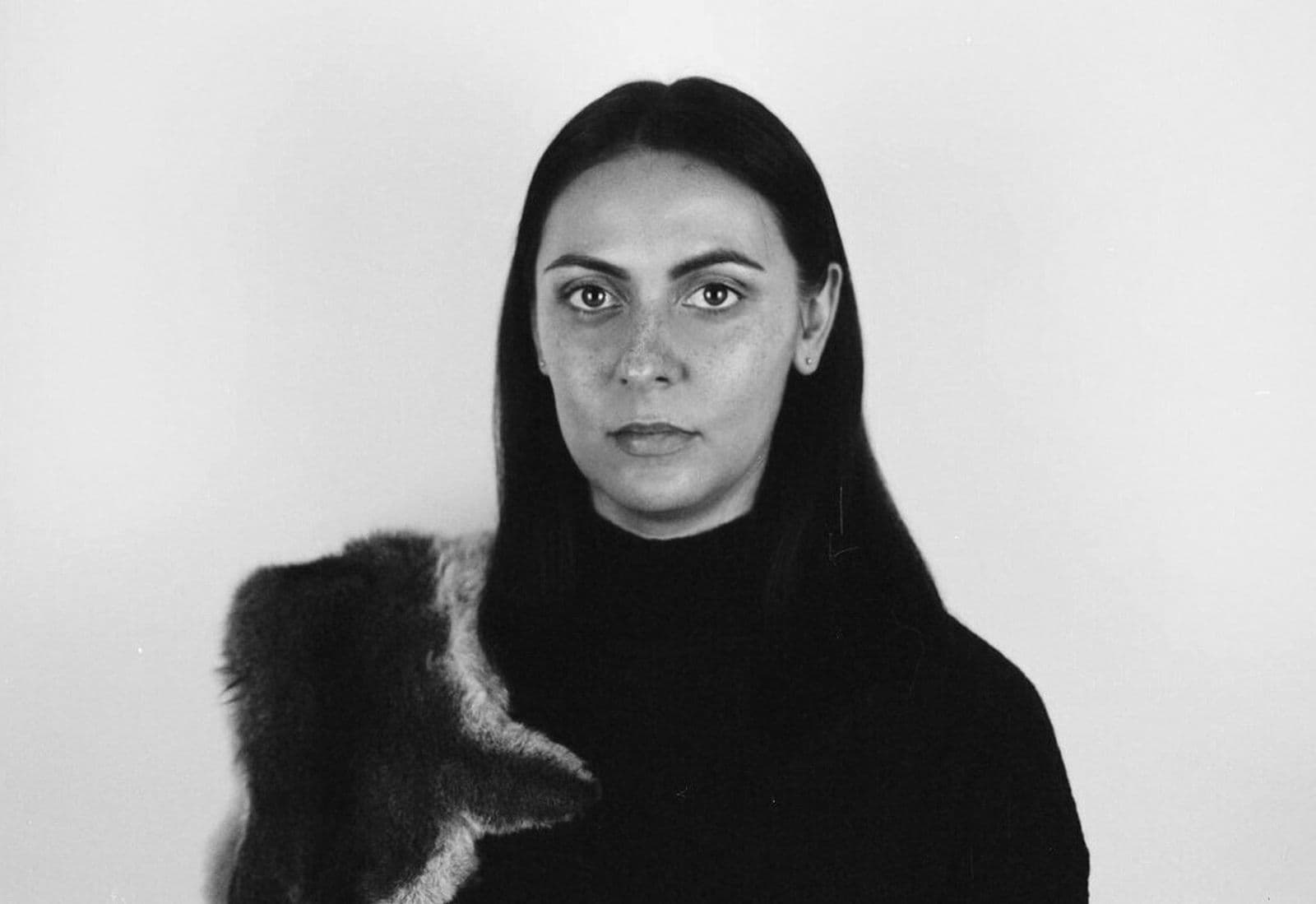 A black and white bust image of Hayley Millar Baker looking directly into the camera