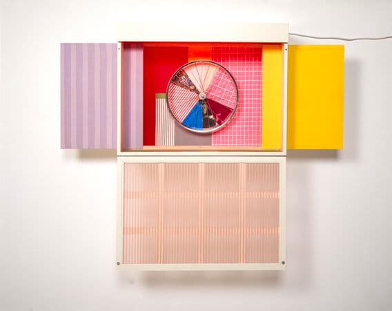A sculpture made from enamel on wood construction, collaged laminated silk, cotton, bicycle wheel, fluorescent light fixture, perspex, enamel on polished aluminium.