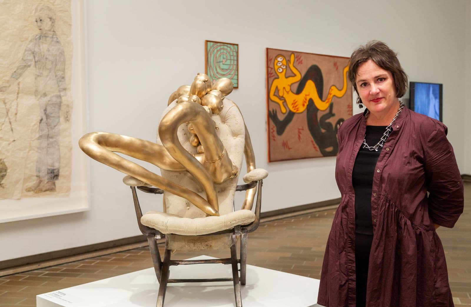 A woman standing in an art exhibition space