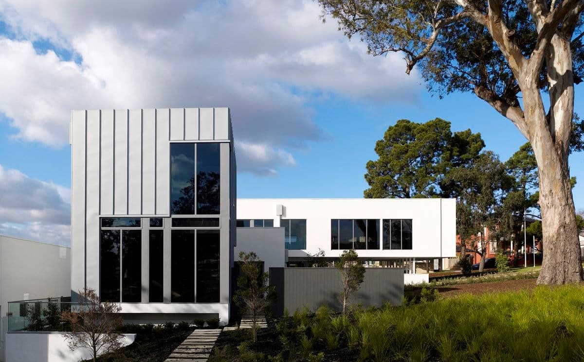 Photograph of white building exterior with blue sky