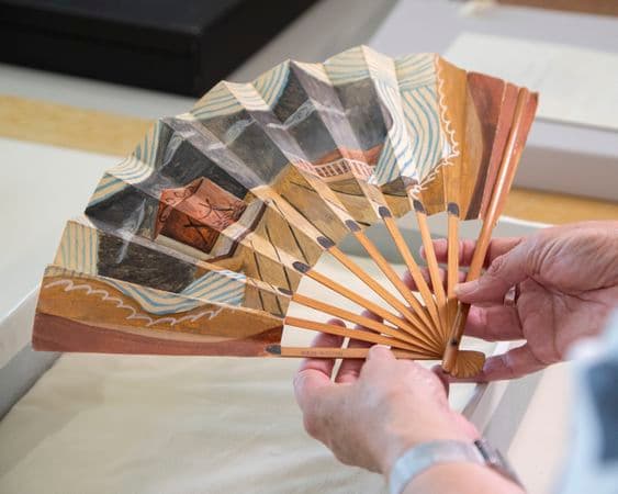Close up photograph of illustrated paper fan