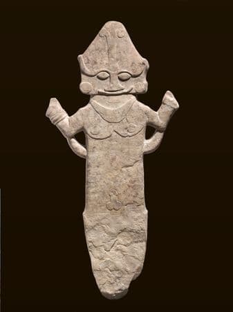 Large flat sculpture of a figure carved in stone