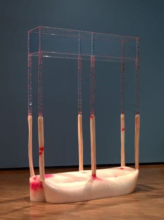 A sculpture made from plastic and latext. A table shape, with the mirror image of a table above it.
