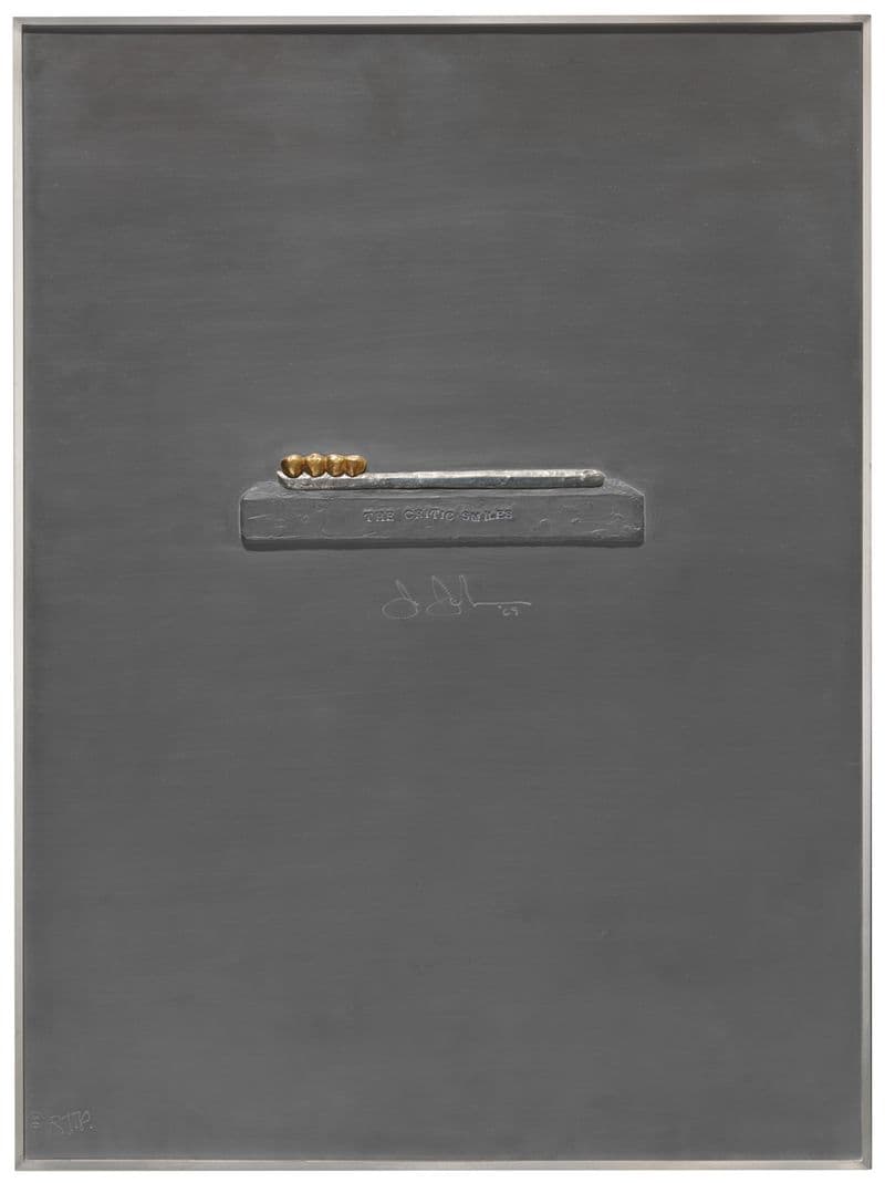A lead relief - black background with a toothbrush imprint and four gold teeth as the bristles