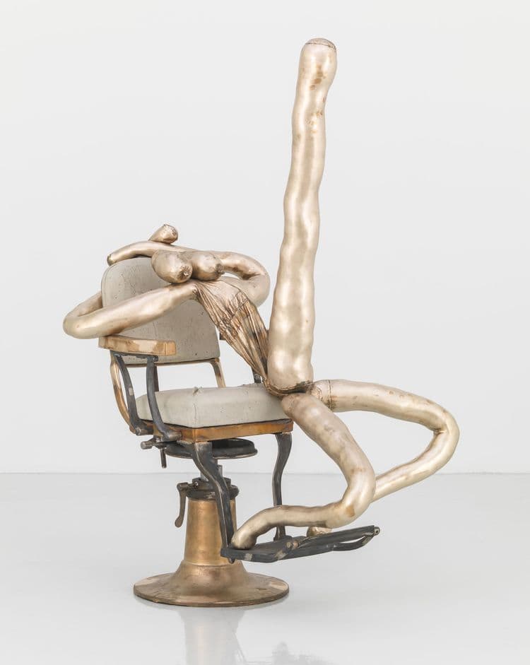 bronze, cast iron and concrete sculpture depicting abstract figure sitting on chair