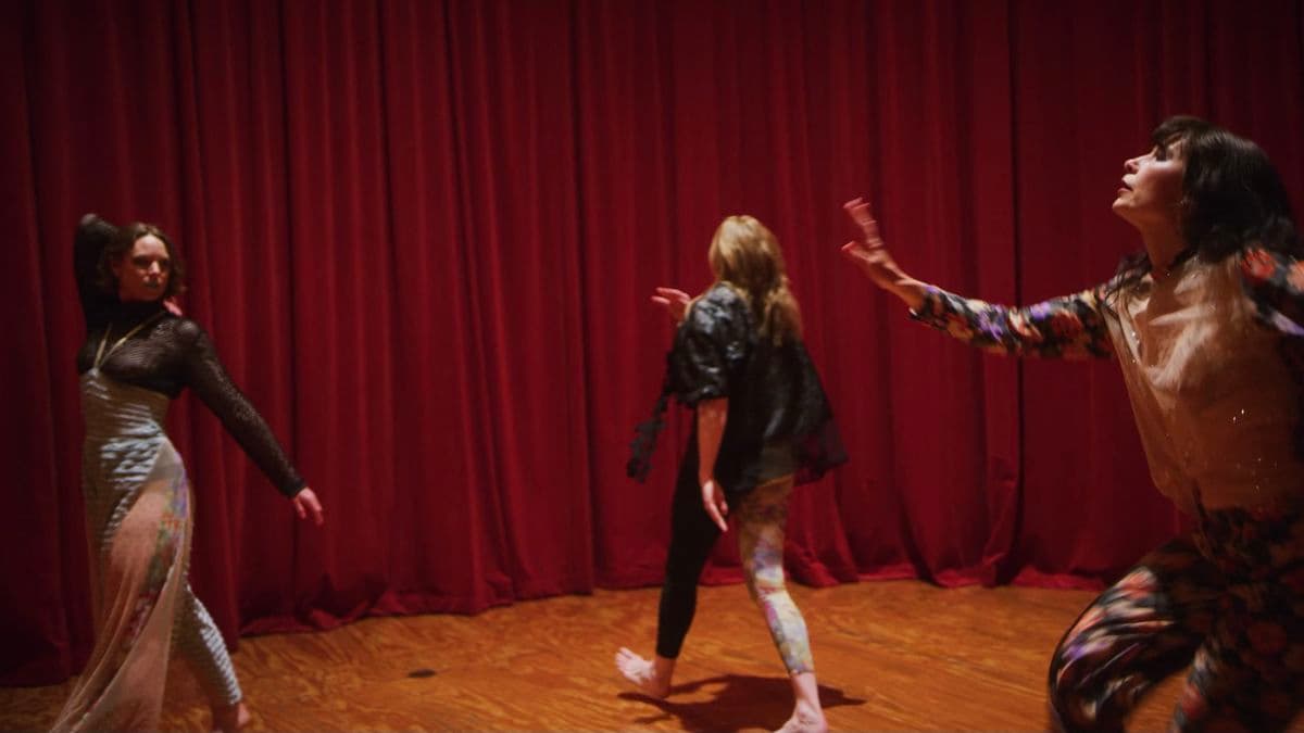 Video still of three women dancing.