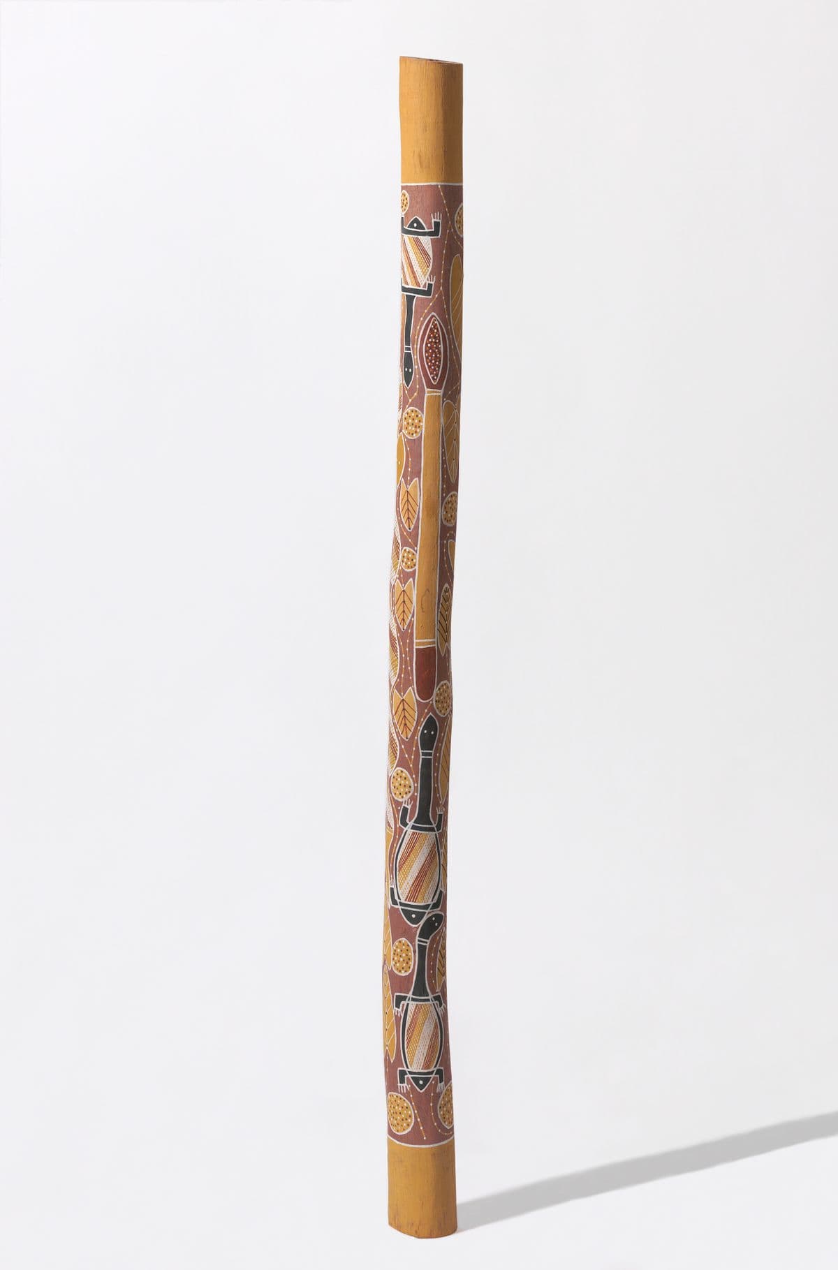 Tall and thin pole with yellow, ochre, black and white Pythons, leaves, and tortoise designs