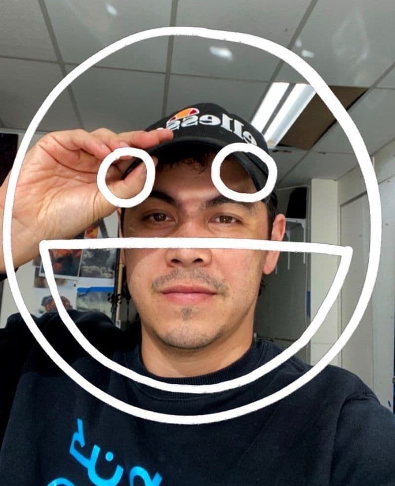 A selfie of a man with a stick figure face superimposed on top