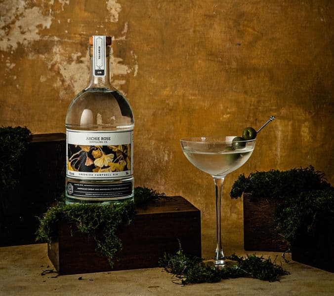 Image of gin bottle featuring floral design beside a martini