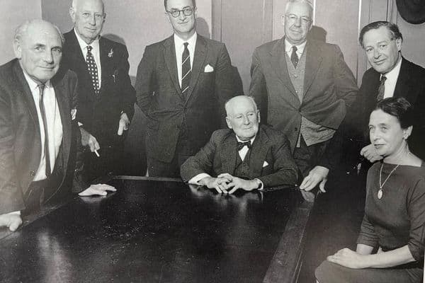 Black and white photograph of The Commonwealth Art Advisory Board c. 1958 Standing left to right: Robert Campbell, Sir Daryl Lindsay, Bill Cumming, Douglas Pratt, Sir William Dargie, Seated: Sir William Ashton (Chairman), Valda Leehy (Secretary) Photo: courtesy Jean Campbell, Canberra
