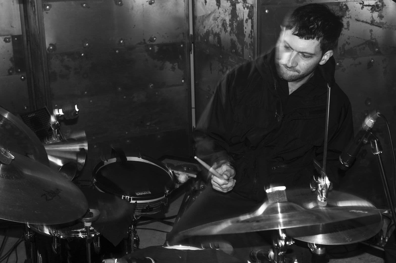 A black and white picture of a male percussionist.