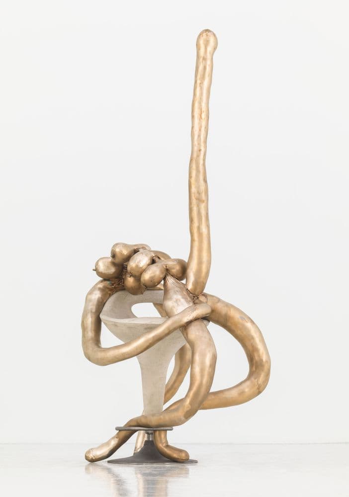 bronze, concrete and cast iron sculpture depicting abstract figure sitting on stool