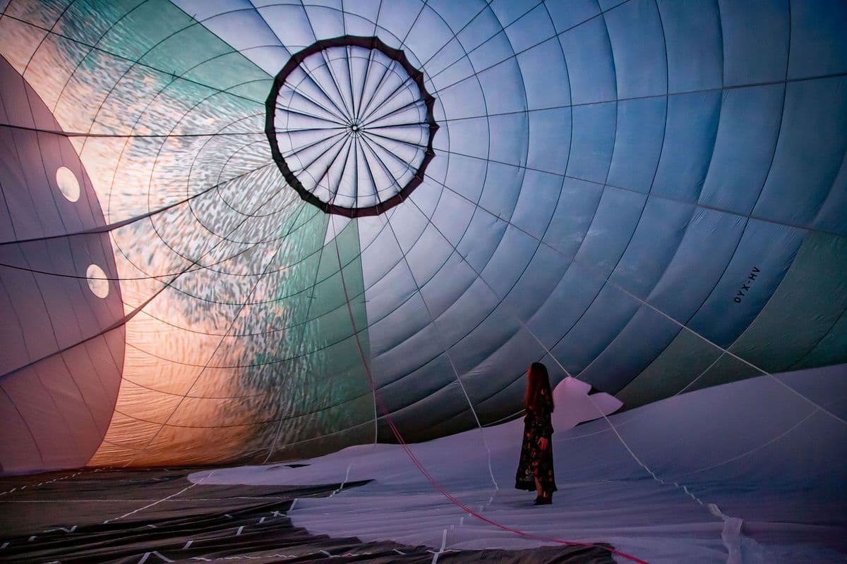 Photo of a woman standing inside a hot air balloon